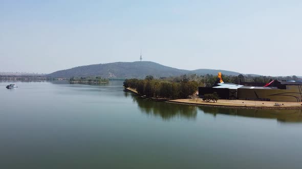 Flying over a beautiful Canberra lake towards the National Museum of Australia and Telstra Tower.