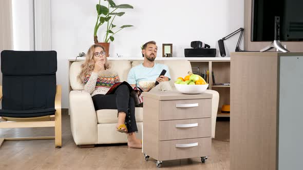 Revealing Shot of Couple Watching TV in Living Room