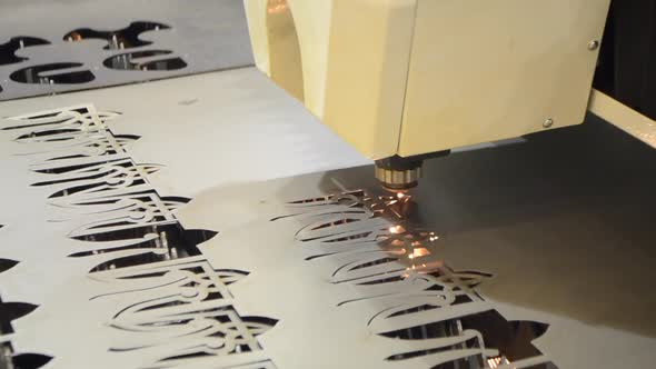 A Laser Beam Cuts the Sheet Metal in the Manufacture