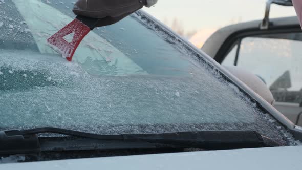 Closeup of Scraping Ice Off a Car Windshield