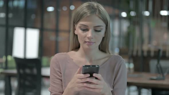 Portrait Shoot of Young Woman Scrolling on Smartphone