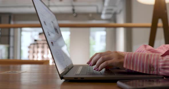 Hands of woman, female digital nomad or student writing, typing on laptop, working online