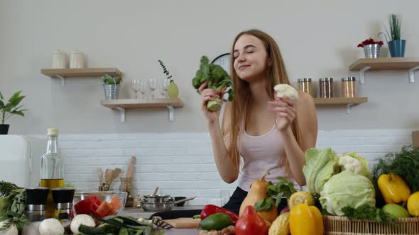 Girl Recommending Eating Raw Vegetable Food. Showing Broccoli and Cauliflower. Weight Loss, Diet