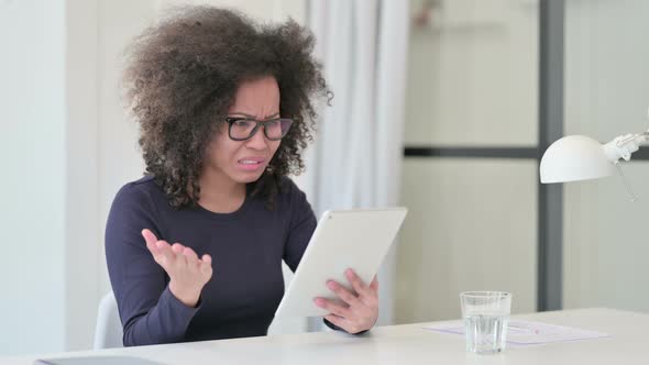 Disappointed African Woman Reacting To Loss on Tablet