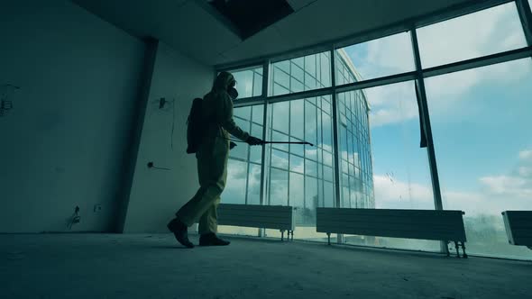 Sanitary Worker Is Disinfecting Panoramic Windows in an Empty Room