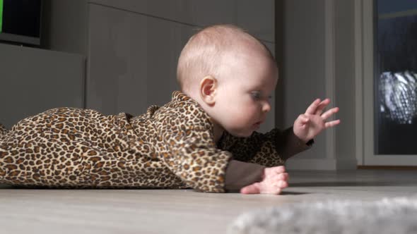 Caucasian toddler awake at night. turns on to front on living room floor