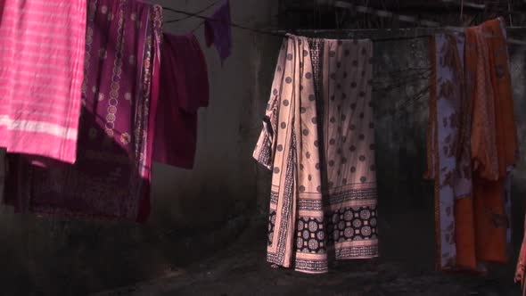 Beautiful, Colorful Saris Drying And Swaying At House Exterior 