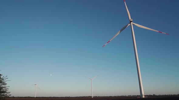 Three Wind Turbines are Operating at Full Capacity Around the Clock in the Field / Videohive, Stock footage, Industrial