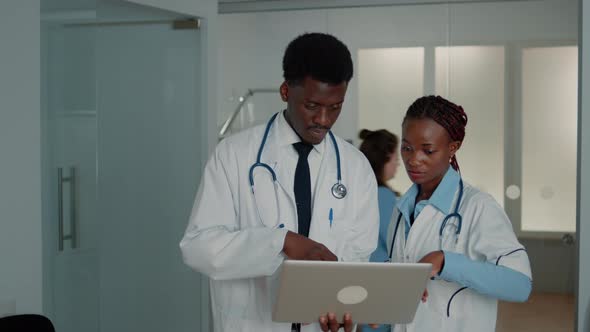 Team of African American Doctors Working with Laptop