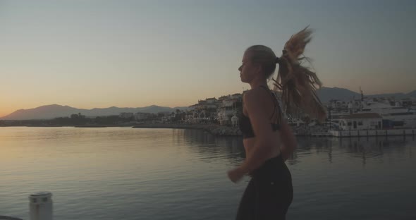 Beautiful Athlete Jogging Along Promenade At Sunset