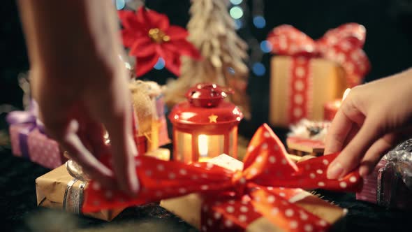 The Hand Is Opening a Christmas Gift Box, Christmas Ball on Glow Bokeh Lights Background