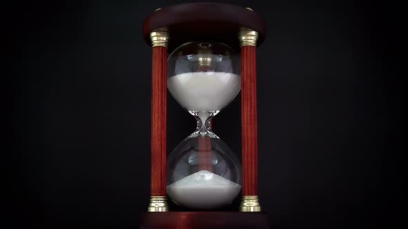 Rotating Hourglass On The Black Background.