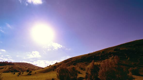  UHD Mountain Meadow Timelapse at the Summer. Clouds, Trees, Green Grass and Sun Rays Movement.