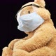 brown teddy bear sits in protective plastic glasses - VideoHive Item for Sale