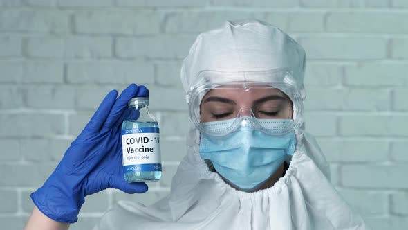 Female Scientist Holding Covid-19 Vaccine in Hand, New Medication Developing, Vaccination. Syringe