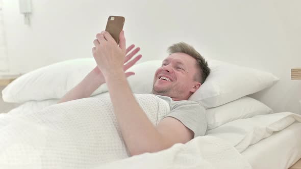 Man Video Calling While Sleeping in Bed