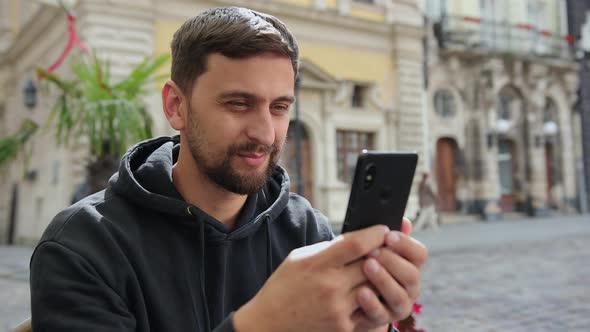 Portrait Business Man Reading Message with Smart Phone in Outdoor Video Calls