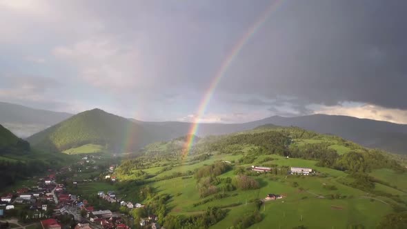 Aerial View of Double Rainbow above Green Country Landscape in Summer Rainy Evening