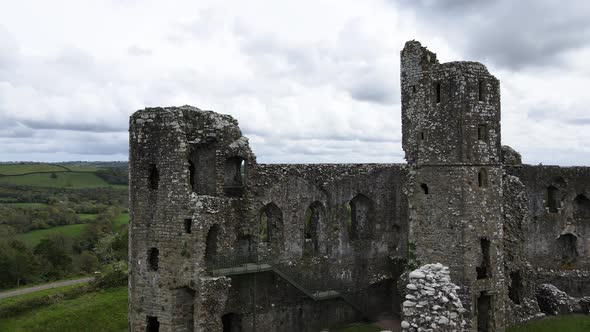 Llawhaden castle ruins in Welsh countryside, Pembrokeshire in Wales, UK. Aerial backward ascending