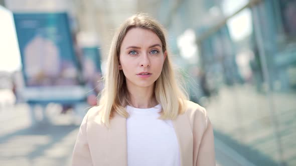 portrait confident serious young woman outdoors looking at camera 