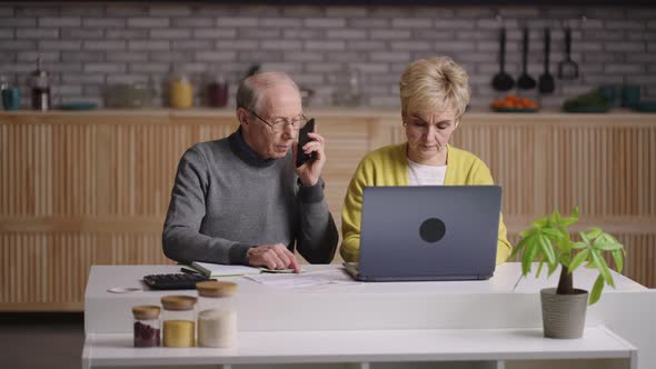 Retirees are Calculating Expenses Planning Budget and Calling to Bank Portrait of Old Spouses at