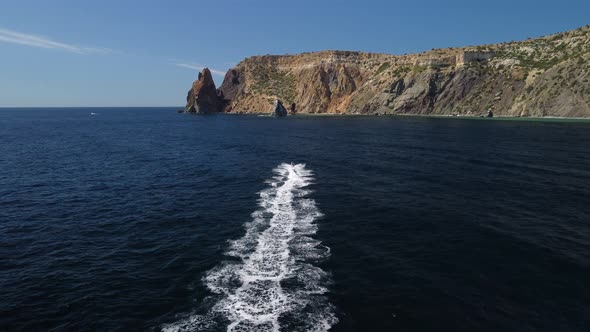 People are Playing a Water Bike in the Sea Leaving Abstract White Footprints on the Water