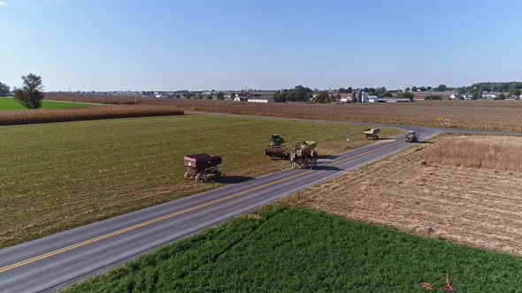 Drone Flight over Agricultural Fields and Wheat Fields being Harvested by Amish Farmer and Horses