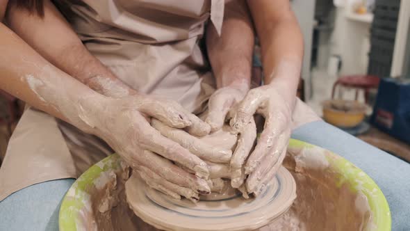 Couple Hands Making a Pot on a Pottery Workshop