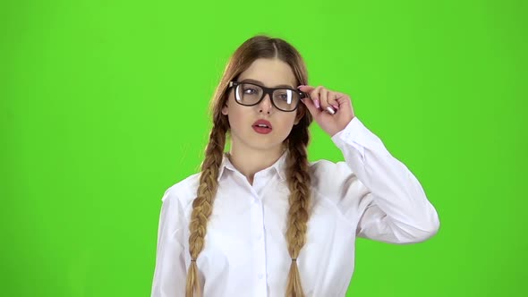 Schoolgirl Takes Off Her Glasses, She Is Tired. Green Screen. Slow Motion