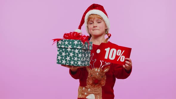 Toddler Girl in Christmas Hat Showing Gift Box and 10 Percent Discount Inscriptions Banner Text Note