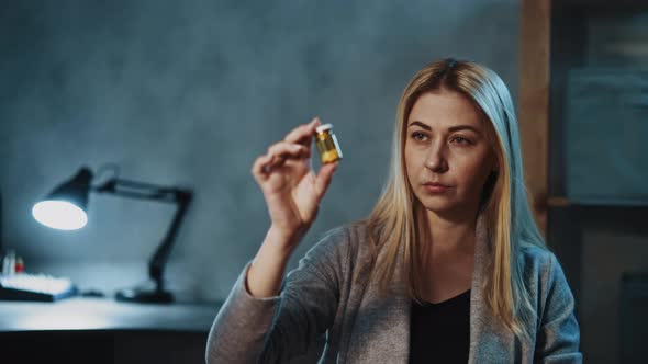 Skeptical Woman Holds Pill Bottle with Supplement in Office