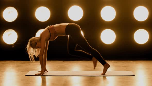 Beautiful Woman Working Out In Front Of A Wall Of Lights
