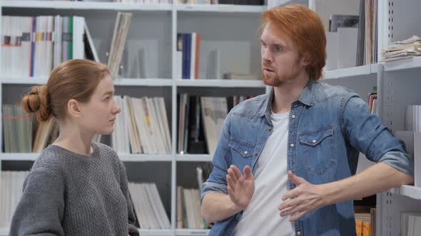 Creative Wise Man Discussing Idea with Young Woman at Work