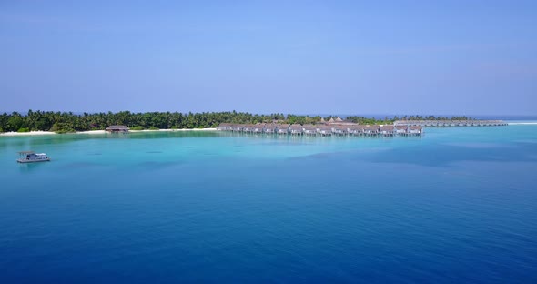 The Beautiful And Peaceful Over Water Bungalow Resort In Tahiti With Trees And Clear, Clean, Transpa