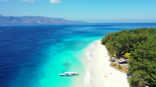 Wide angle flying abstract shot of a summer white paradise sand beach and aqua blue water background