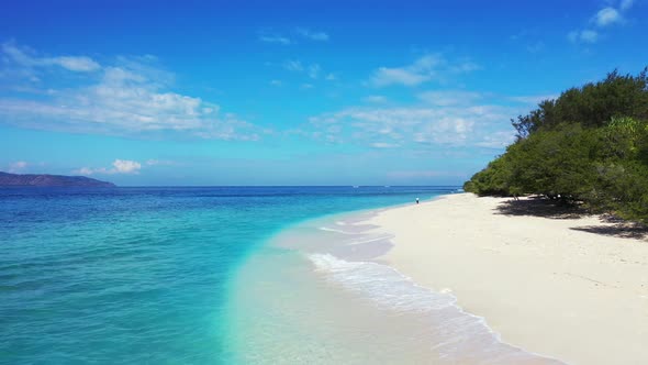 Paradise island with long white sand beach. Tourist enjoying a walk on a sunny day