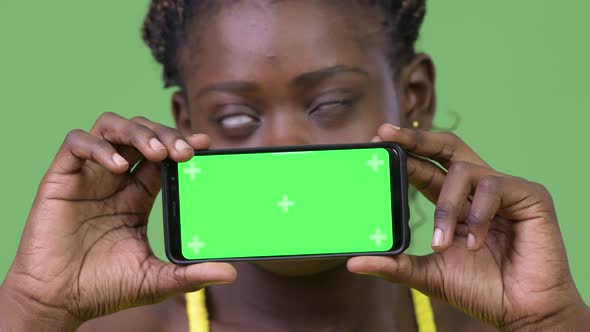 Young African Woman Showing Phone