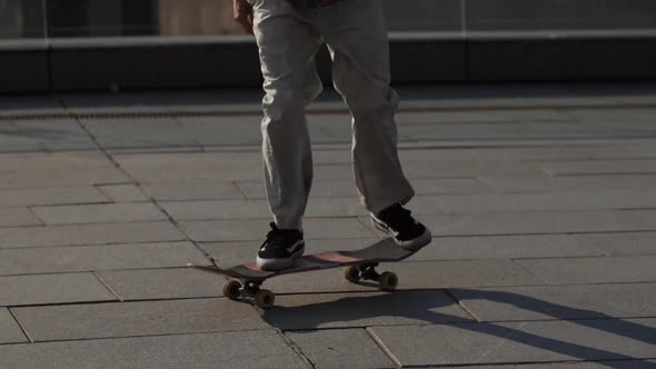 Legs of Skater Doing Kickflip Trick Outdoors