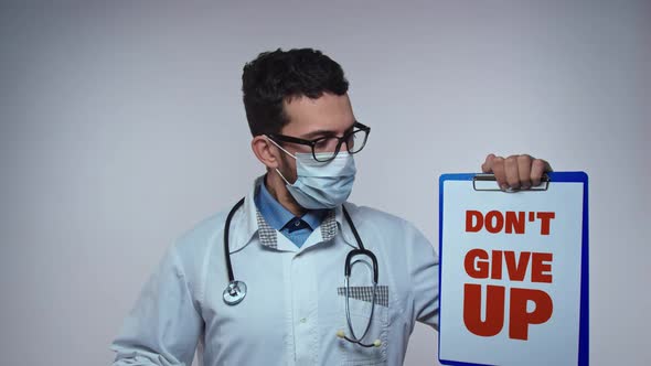 The Doctor in a Mask and Gloves Holds a Form with the Inscription Dont Give Up