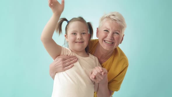 Smiling Aged Woman and Her Handicapped Granddaughter