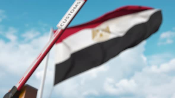 Closing Barrier with CUSTOMS Sign Against the Egyptian Flag alt