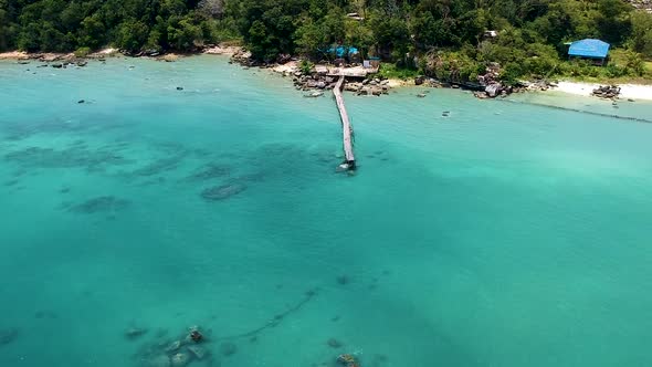 Aerial of beautiful turquoise blue sea with old wooden pier Koh Rong Sanloem, Cambodia