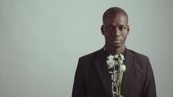 Man In Suit Holding Flower Bouquet