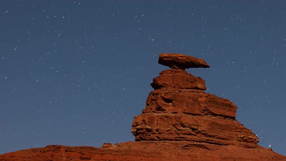 Time lapse of the night sky behind the rock formation of Mexican Hat