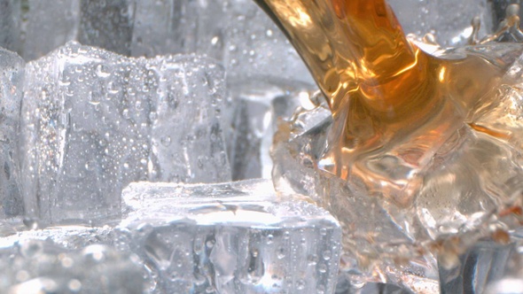 Liquor With Ice Pouring In A Glass In High Speed