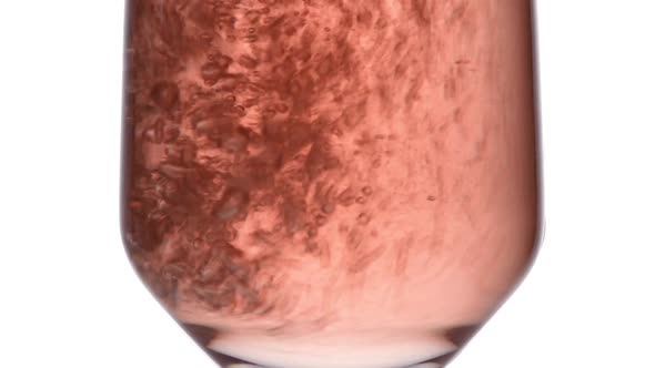Closeup of Glass with Sparkling Rose Wine Decorated Gold Star Confetti