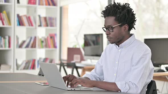 African Man Working on Laptop