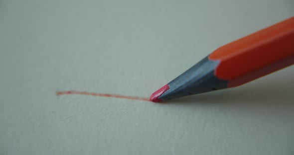 Graphite Orange Color Pencil Draws a Straight Line on a White Background Paper Special Paper for the