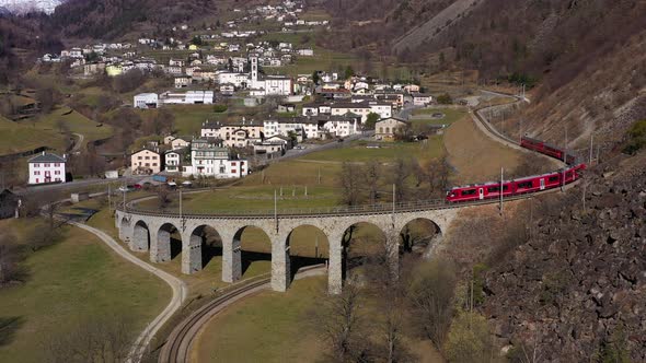 Train on Brusio Spiral Viaduct in Switzerland