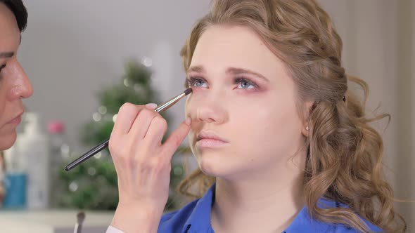 Work of a Makeup Artist. Applying Shadows To the Eyelid of the Model's Eye.